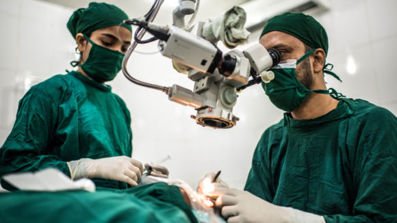 Surgical staff perform a cataract operation.