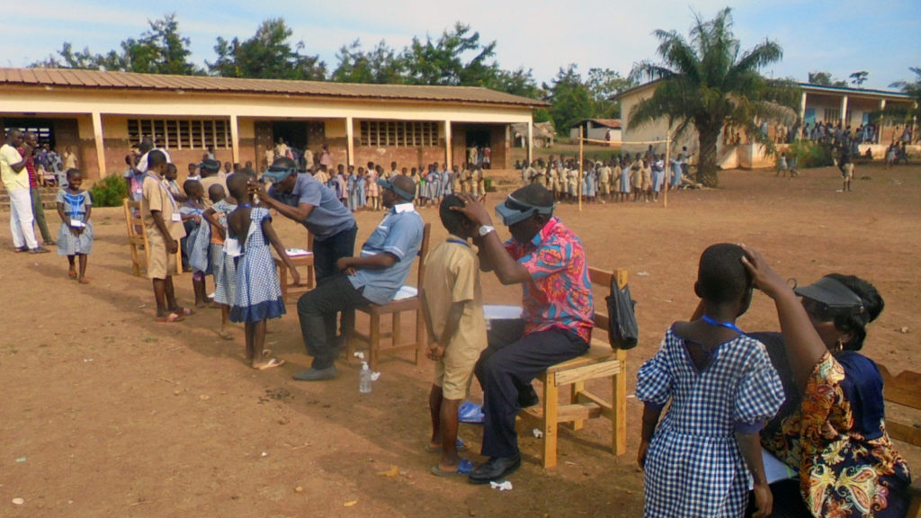 A chldren que to be examined be health workers in Cote d'Ivoire.