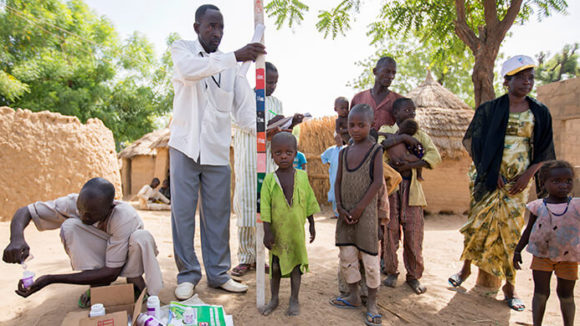 Children in northern Nigeria wait to receive medication as part of a mass drug distribution programme to treat NTDs.