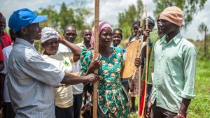 Students practice using measuring sticks to calculate drug dosages at a Volunteer Distributor Training course at the Kibwoona Health centre in Masindi, Uganda.
