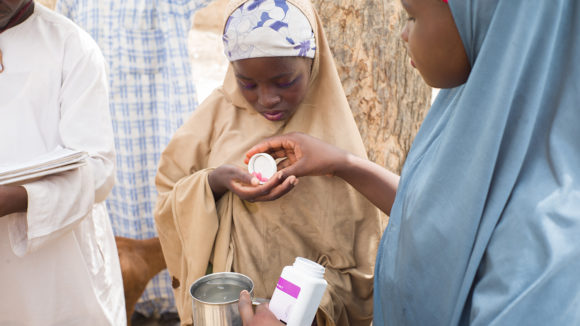 A girl in Kenya receives her medication to protect against river blindness and lymphatic filariasis.