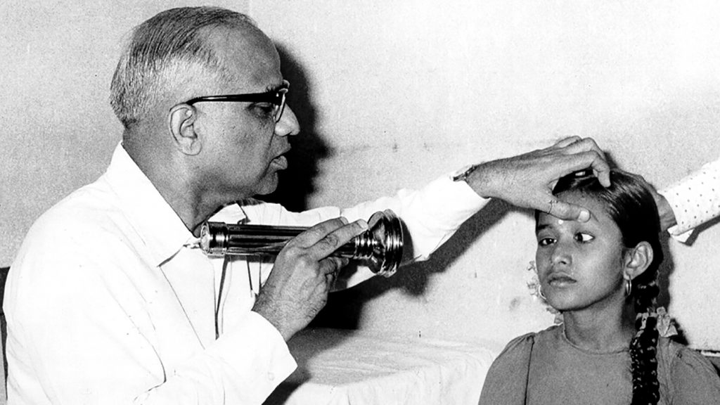 A doctor examines a girl's eyes in India in the 1950s.
