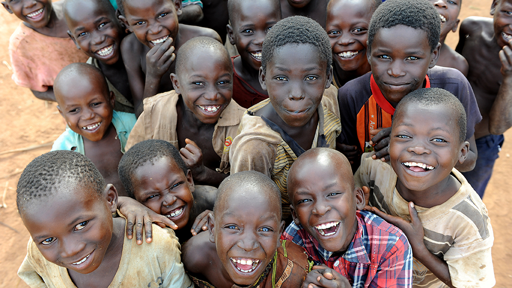 A group of smiling schoolboys in Kasuleta, a small rural village in Uganda.