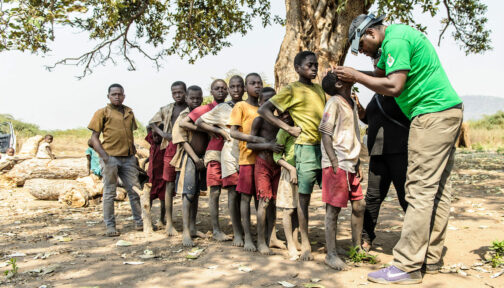 An eye health worker screens children for eye conditions.