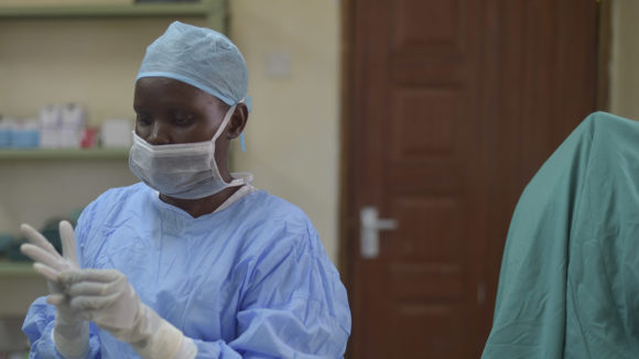 A surgeon dressed in scrubs prepares for theatre