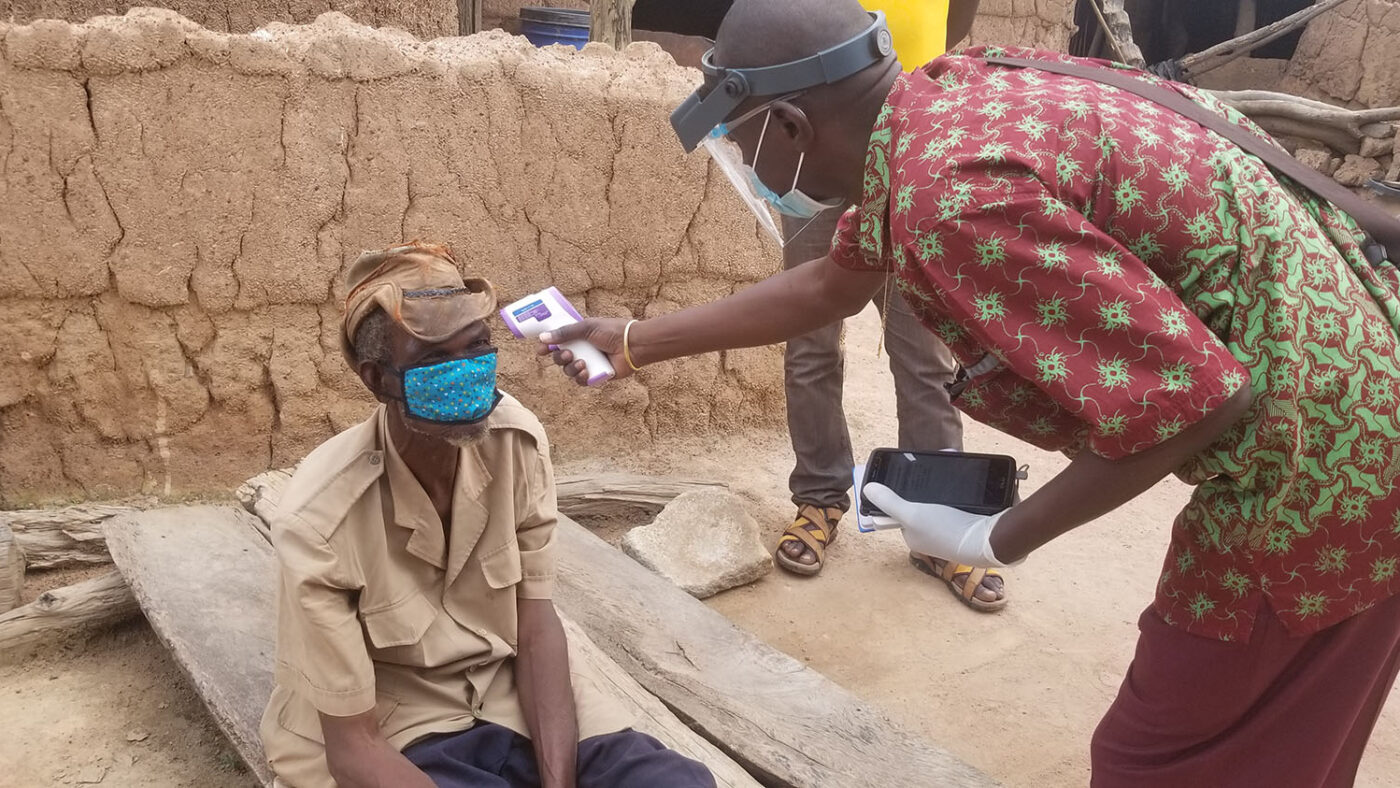 A man has his temperature checked before participating in a Tropical Data trachoma survey.
