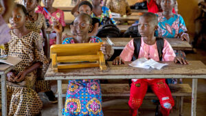 Children sit in a classroom.