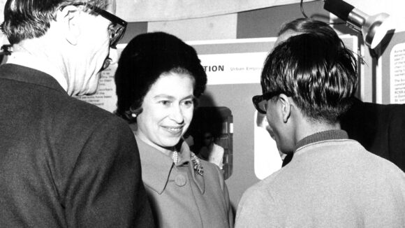 The Queen smiles as she greets staff.